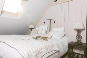 a dog laying on a bed in a bedroom at Les Demeures de Marie in Pacé