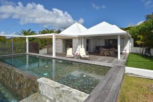 a swimming pool in front of a house at Dream Villa Mont Jean 657 in Saint Barthelemy