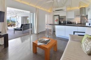 a living room and kitchen with a couch and a table at Dream Villa Mont Jean 657 in Saint Barthelemy