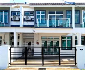 a house with a black fence in front of it at MARI Residence in Kuala Terengganu