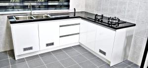 a kitchen with white cabinets and a sink at MARI Residence in Kuala Terengganu +12 photos
