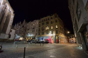 a large building on a city street at night at Jacob Brno Apartments in Brno