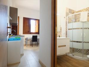 a kitchen with a sink and a table in a room at Appartamenti Leone1 in San Vito lo Capo +46 photos