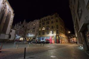 a large building on a city street at night at Jacob Brno Apartments in Brno