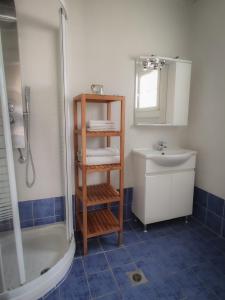 a bathroom with a shower and a toilet and a sink at ammos seafront family apartments in Nea Plagia