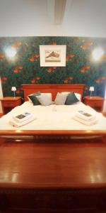 a bedroom with a large bed with two towels on it at Privathotel Der Schwarze Herrgott No TV in Zellertal