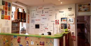 a kitchen filled with lots of magnets and pictures on the wall at A Casa di Amici in Palermo