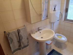a bathroom with a sink and a toilet at Casa Ester in Castelpetroso