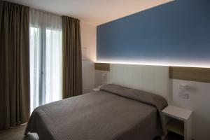 Postel nebo postele na pokoji v ubytování Almalux Jesolo Wellness & Spa 3 stelle superior