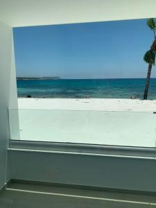 a view of the beach from a window at Karousos Beach Rooms in Ayia Napa