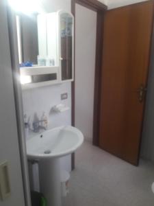 a bathroom with a white sink and a mirror at Casa Vacanze Messano in Paduli