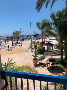 a view of the beach from a balcony at Karousos Beach Rooms in Ayia Napa
