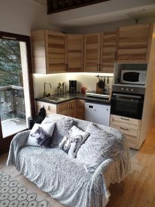 a kitchen with a bed in the middle of a room at Appartement T3 50m² - 6 pers. - Barcelonnette in Barcelonnette