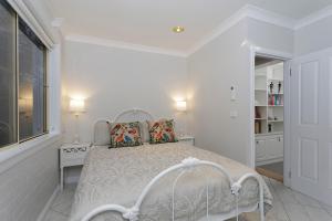 a white bedroom with a bed and a window at Rawson's Retreat - Five Bedroom Home - Walk CBD - Includes Breakfast in Tamworth