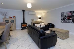 a living room with a couch and a fireplace at Rawson's Retreat - Five Bedroom Home - Walk CBD - Includes Breakfast in Tamworth