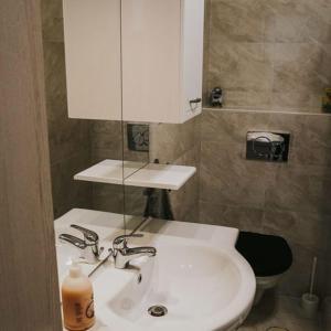 a bathroom with a white sink and a toilet at Elegant Apartman in Siófok +20 photos