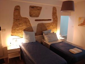 a hotel room with two beds and a wall with a cow on it at Isi GuestHouse in Iesi