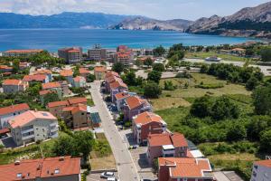 an aerial view of a small town next to the water at Apartments La Natalli in Baška