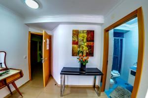 un bagno con tavolo e vaso di fiori di Apartamentos 7 Saias - Centro a Nazaré Altre 54 foto