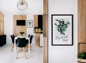 a dining room with a table and a picture at SeaSide Apartment in Rowy