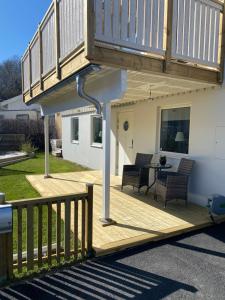 a wooden deck with a staircase on a house at Monekil 8 in Hamburgsund