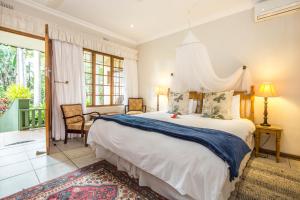 a bedroom with a large bed in a room at Wendy's Country Lodge in Mtubatuba +108 photos