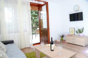 a living room with a bottle of wine on a table at Zoja in Vrdnik