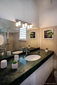 a bathroom with two sinks and a large mirror at Dream Villa Mont Jean 661 in Saint Barthelemy