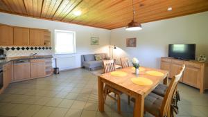 a kitchen and dining room with a table and a couch at Gästehaus Wildgehege in Wilhelm