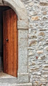 a wooden door in a stone wall at Antico Sogno in Alfano