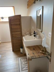 a bathroom with a white sink and a mirror at La Suite du 12 Maison d hôtes in Brie +25 photos