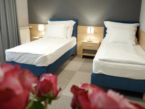 Łóżko lub łóżka w pokoju w obiekcie Hotel Rudnik