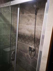 a shower with a glass door in a bathroom at İntepe Poseidon in Canakkale