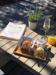 a tray of food and a glass of wine on a table at Blackhome Graz I contactless check-in in Graz