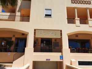 a building with balconies and a sign for a hotel at Praia da Luz Monique Apartment in Luz