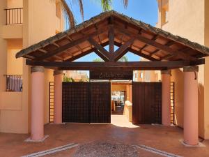 an entrance to a building with a wooden gate at Praia da Luz Monique Apartment in Luz