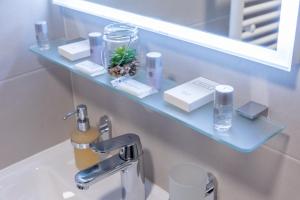 a bathroom with a blue shelf above a sink at Il Giardino Luxury Rooms & Suites in Split +37 photos