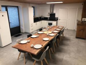 a long wooden table in a room with chairs at Logis de la Tonnellerie in Chambretaud +6 photos