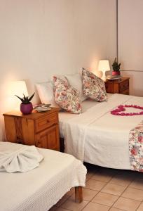 a room with two beds and two tables with lamps at Myra Hotel in Dalyan