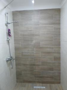 a shower with a glass door in a bathroom at BAKURIANI PLAZA A-109 in Bakuriani