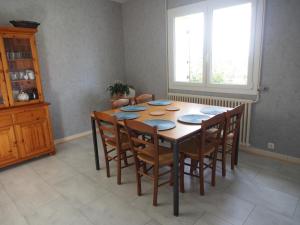 a dining room table with chairs and a window at Escale en Revermont in Saint-Lothain +20 photos