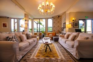 a living room with a large couch and a chandelier at Akasha Retreat in Bran +55 photos