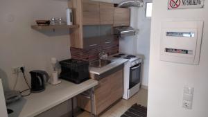 a small kitchen with a sink and a stove at Celia`s Studio in Nea Peramos