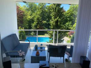 a living room with a view of a pool through a window at Apartment Sonne in Scharbeutz