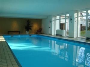 a large blue swimming pool in a building at daheim im hirschen in Schönwald