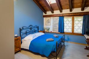a blue bedroom with a bed and a television at Isola Di Wight in San Michele al Tagliamento