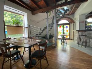 a restaurant with a table and chairs in a room at Hotel La Locanda in Cadrezzate