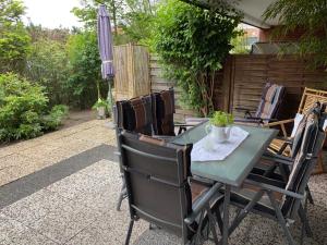 a table and chairs on a patio with an umbrella at Haus Elfi in Grömitz