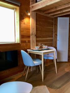 a dining room with a table and two chairs at Gîte Le Mazot de Vouan in Saint-André-de-Boëge +15 photos
