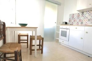 a kitchen with a table and a table and chairs at Casa ALBAYZÍN in Salobreña +22 photos